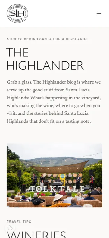 The Highlander journal on a phone — editorial index with article imagery